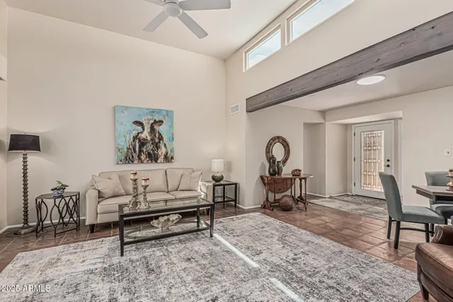 a living room with furniture a rug and a table