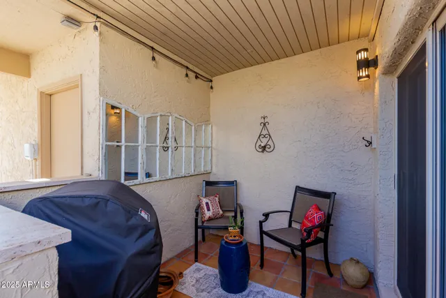 a view of a patio with table and chairs potted plants