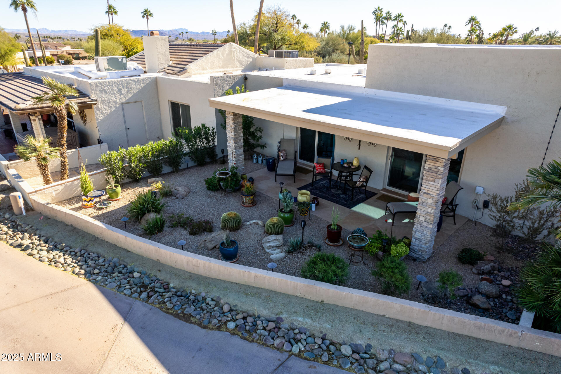 18718 East Rio Lane Rio Verde, AZ 85263 - Photo 36 of 59 a view of a patio with table and chairs potted plants
