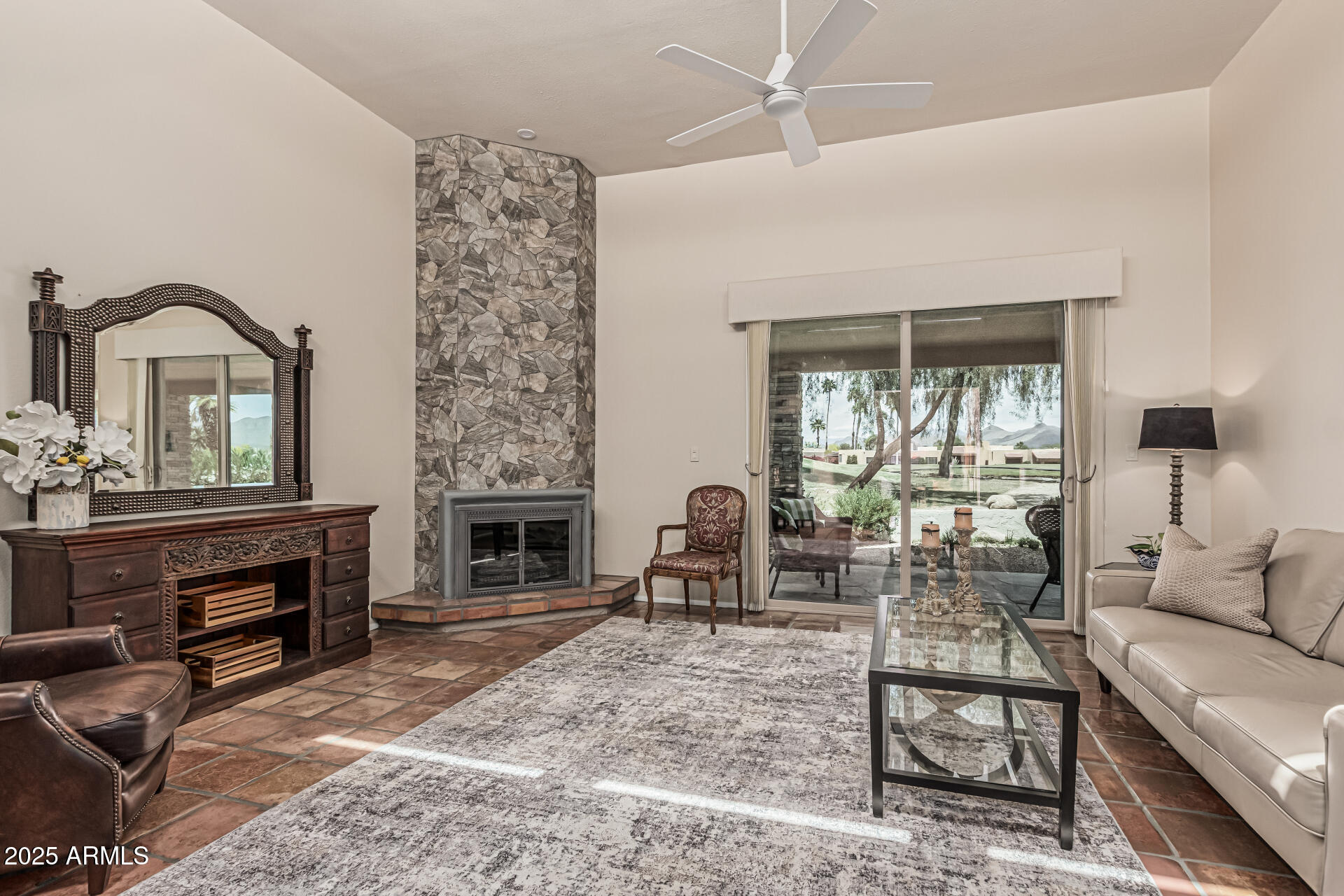 18718 East Rio Lane Rio Verde, AZ 85263 - Photo 5 of 59 a living room with furniture a fireplace and a floor to ceiling window