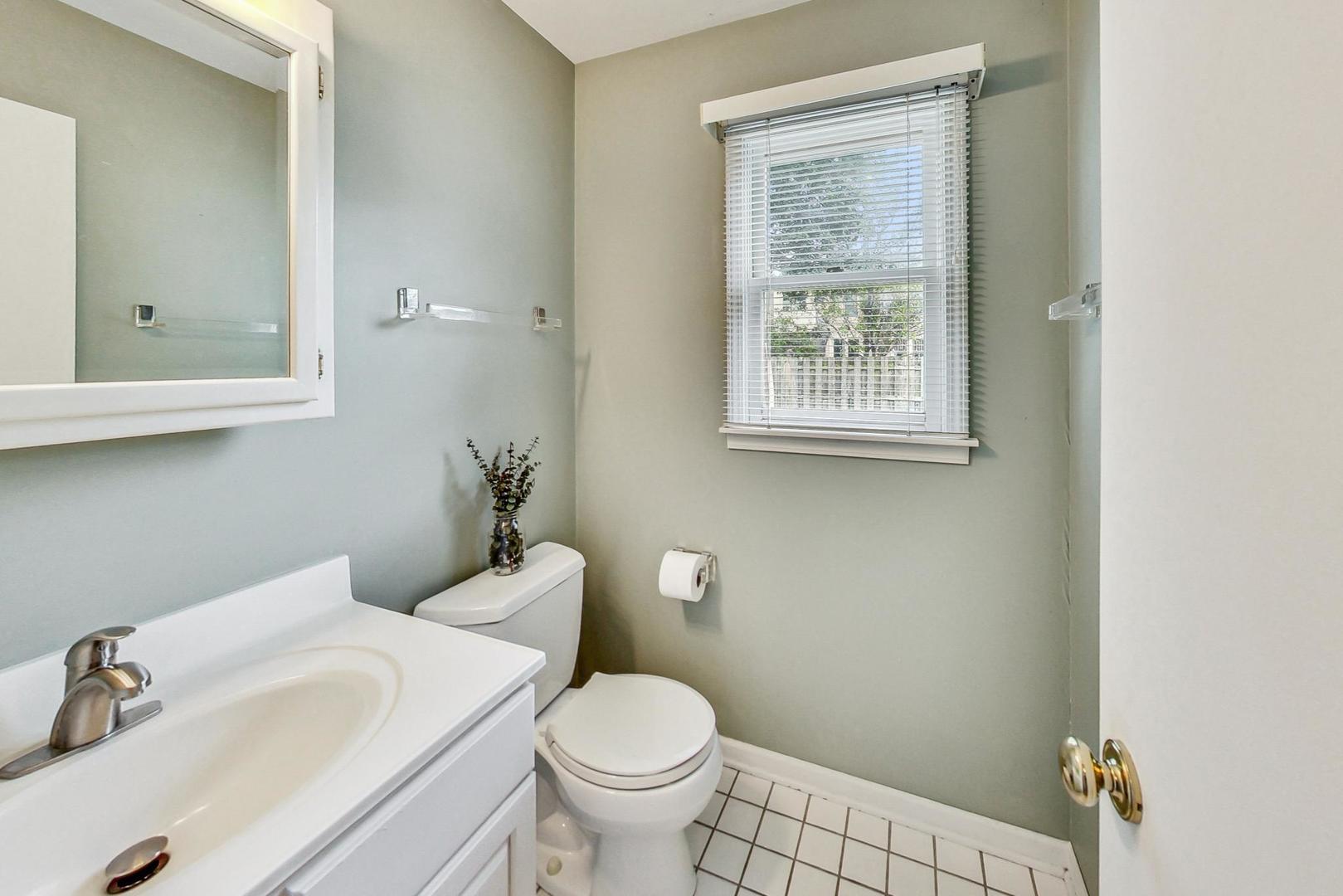1010 Aurora Way Wheaton, IL 60189 - Photo 15 of 37 a bathroom with a sink toilet and a window
