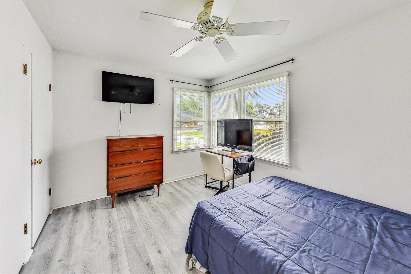 1010 Aurora Way Wheaton, IL 60189 - Photo 19 of 37 a bedroom with a bed and a flat screen tv