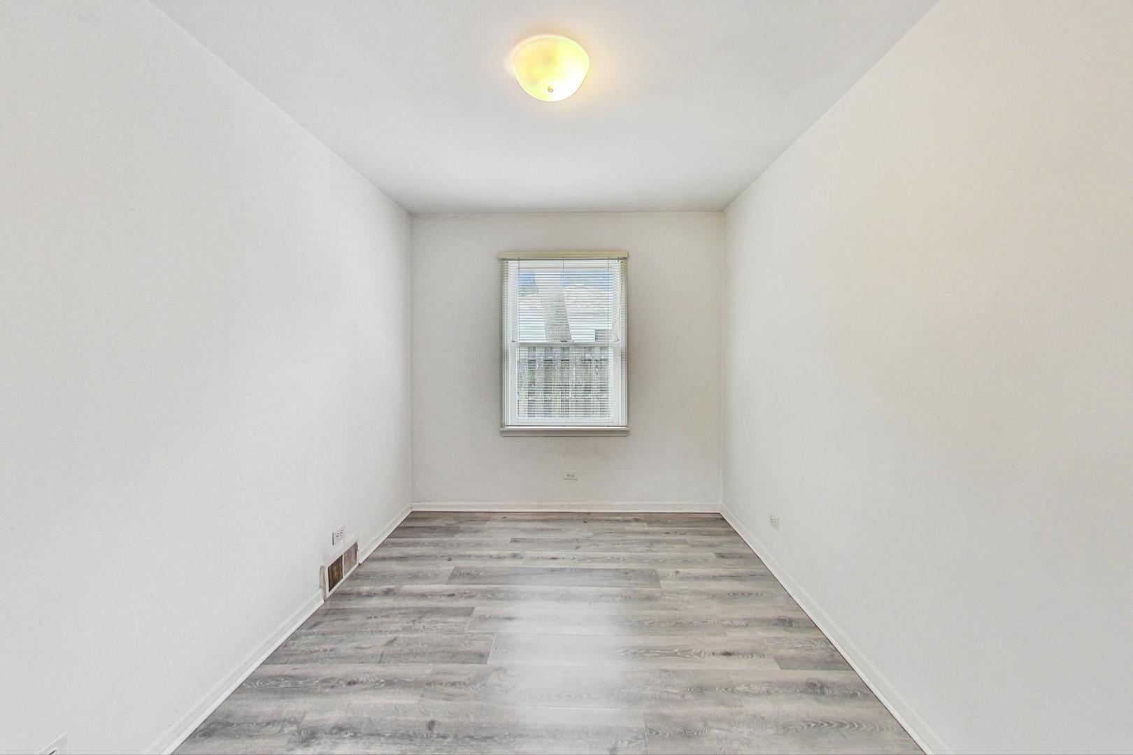 1010 Aurora Way Wheaton, IL 60189 - Photo 22 of 37 a view of an empty room with wooden floor and a window