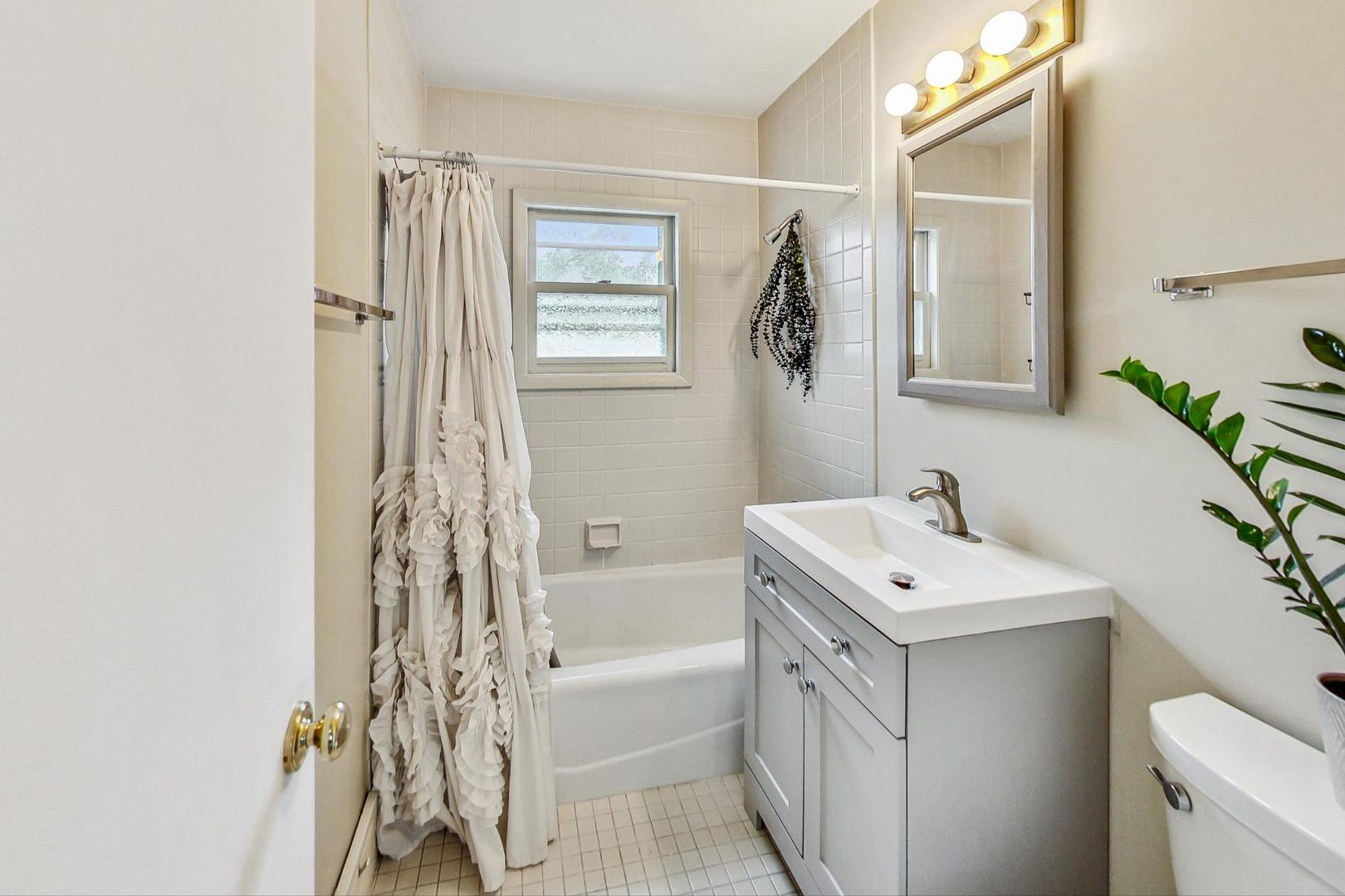 1010 Aurora Way Wheaton, IL 60189 - Photo 25 of 37 a bathroom with a sink a toilet and shower