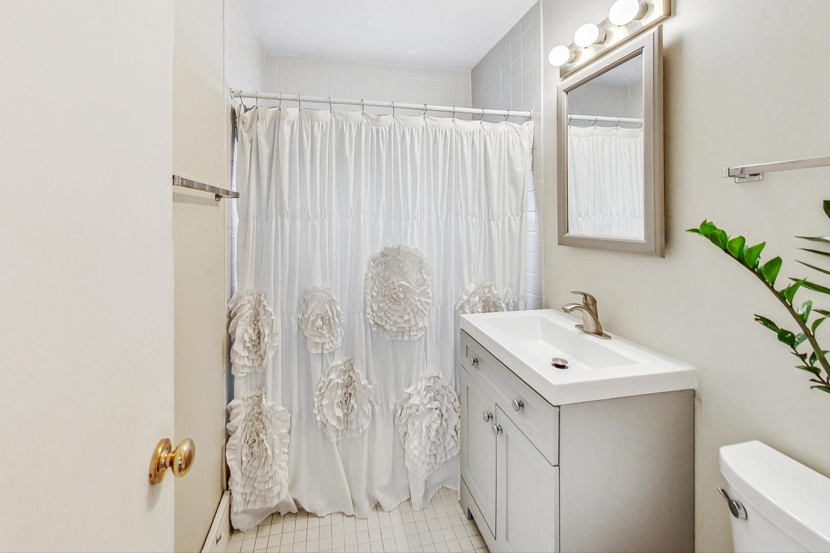1010 Aurora Way Wheaton, IL 60189 - Photo 26 of 37 a bathroom with a sink a toilet and shower