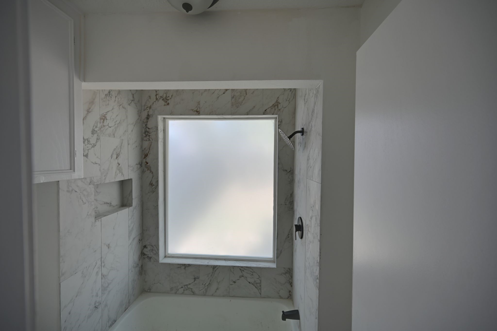 10410 Cook Road Houston, TX 77099 - Photo 11 of 12 a bathroom with a glass shower door