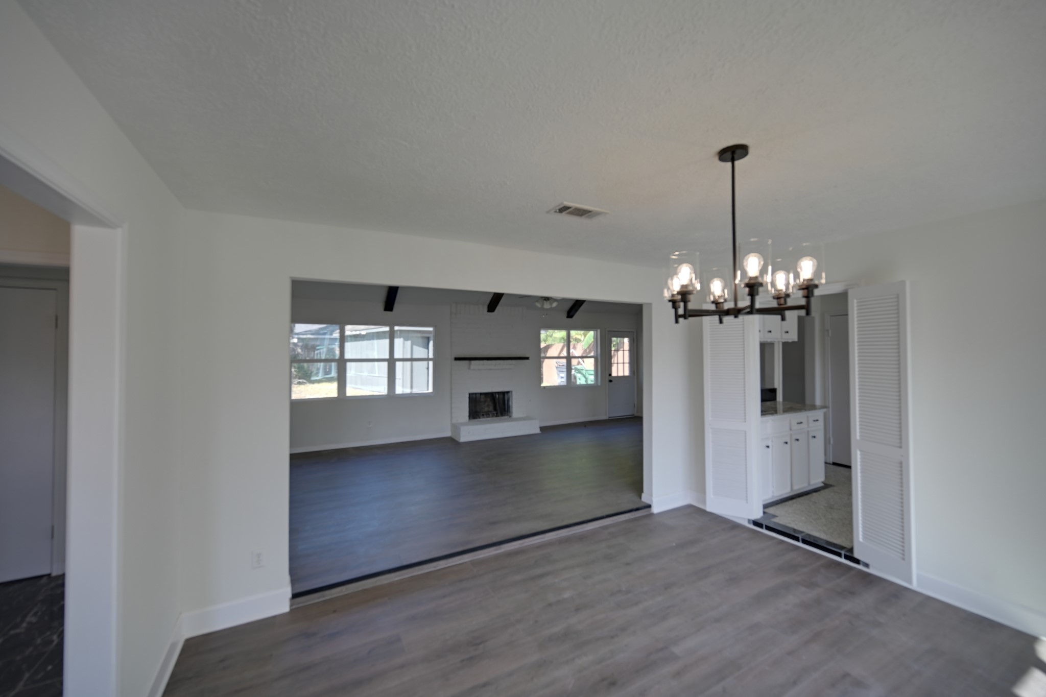 10410 Cook Road Houston, TX 77099 - Photo 5 of 12 a view of a big room with wooden floor kitchen and living room