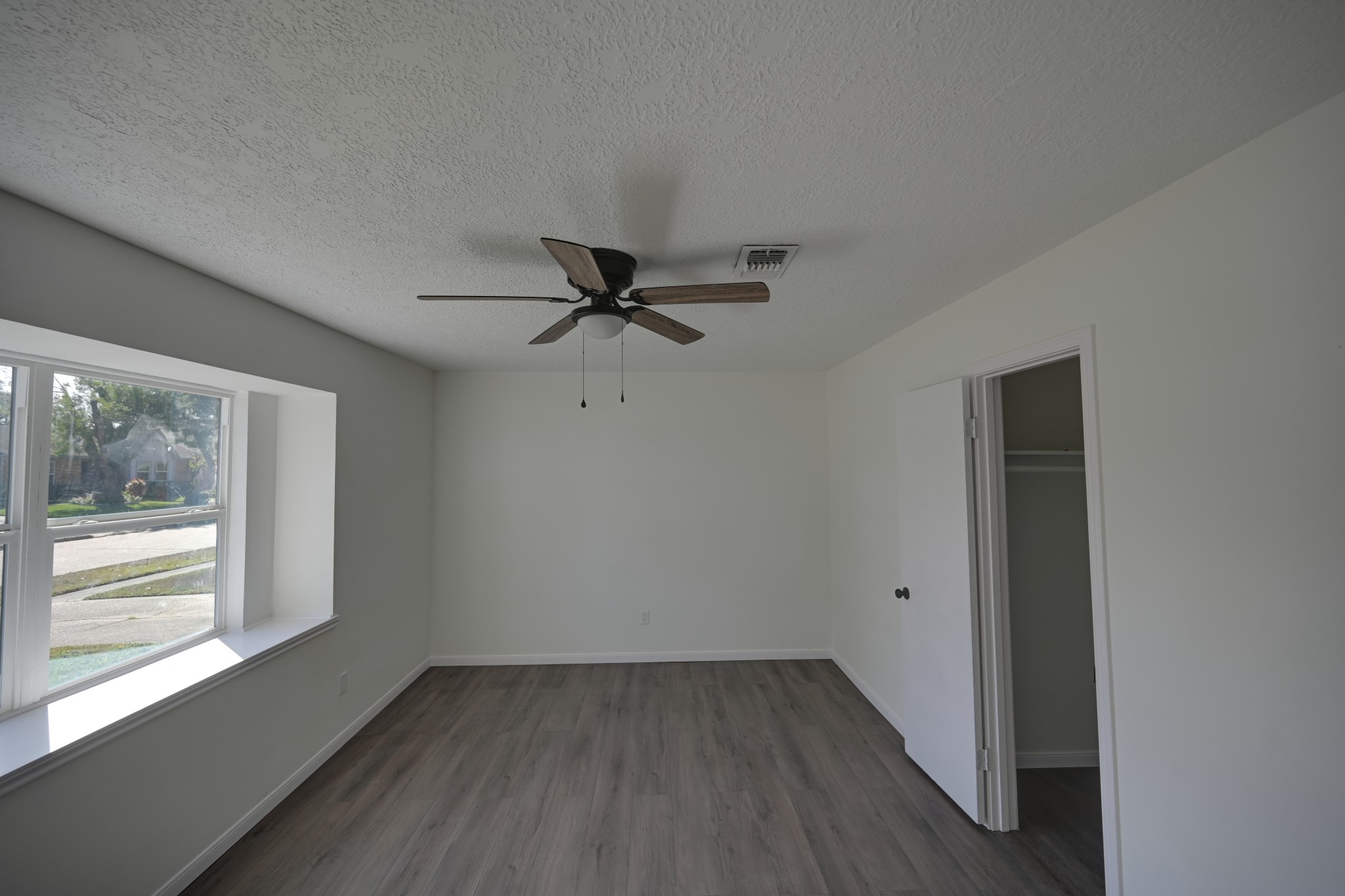 10410 Cook Road Houston, TX 77099 - Photo 7 of 12 wooden floor in an empty room with a window