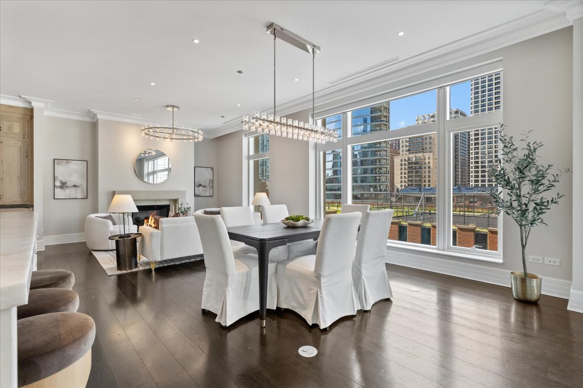 9 West Walton Street, Unit 702 Chicago, IL 60610 - Photo 15 of 38 a dining room with wooden floor and furniture