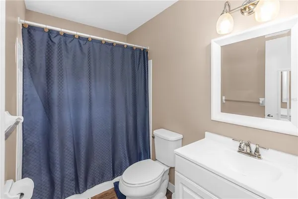 a white toilet sitting next to a bathroom sink
