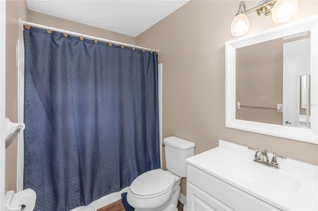 a white toilet sitting next to a bathroom sink