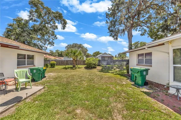 a view of backyard of house with green space