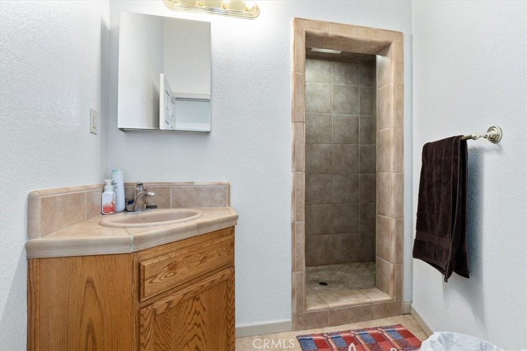 67911 Jolon Road Lockwood, CA 93932 - Photo 17 of 29 a bathroom with a sink a toilet and shower
