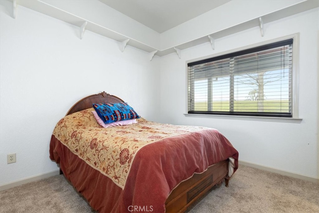 67911 Jolon Road Lockwood, CA 93932 - Photo 18 of 29 a bed sitting in a bedroom next to a window