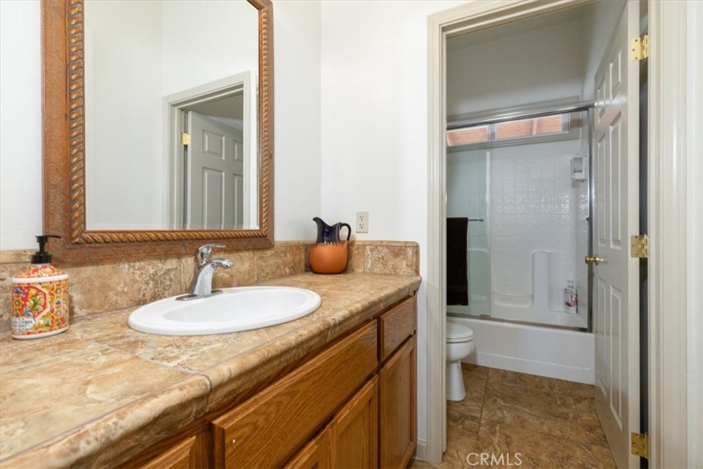 67911 Jolon Road Lockwood, CA 93932 - Photo 21 of 29 a bathroom with a granite countertop sink and a mirror