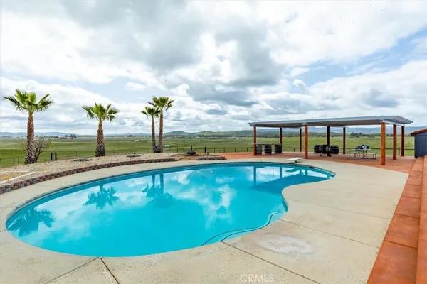 a view of a swimming pool with a patio