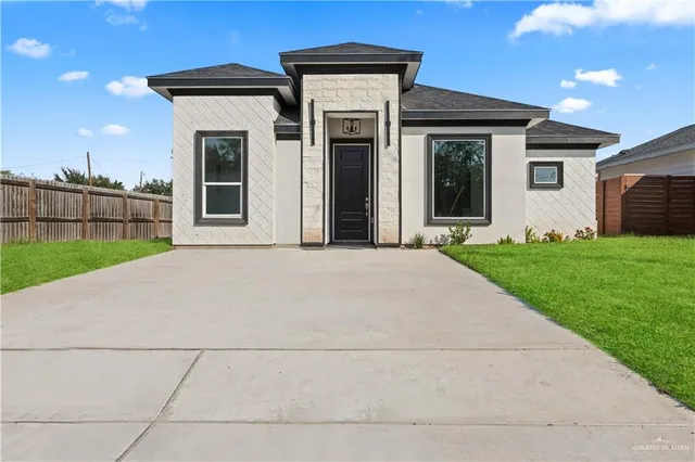 a view of a house with a yard and garage