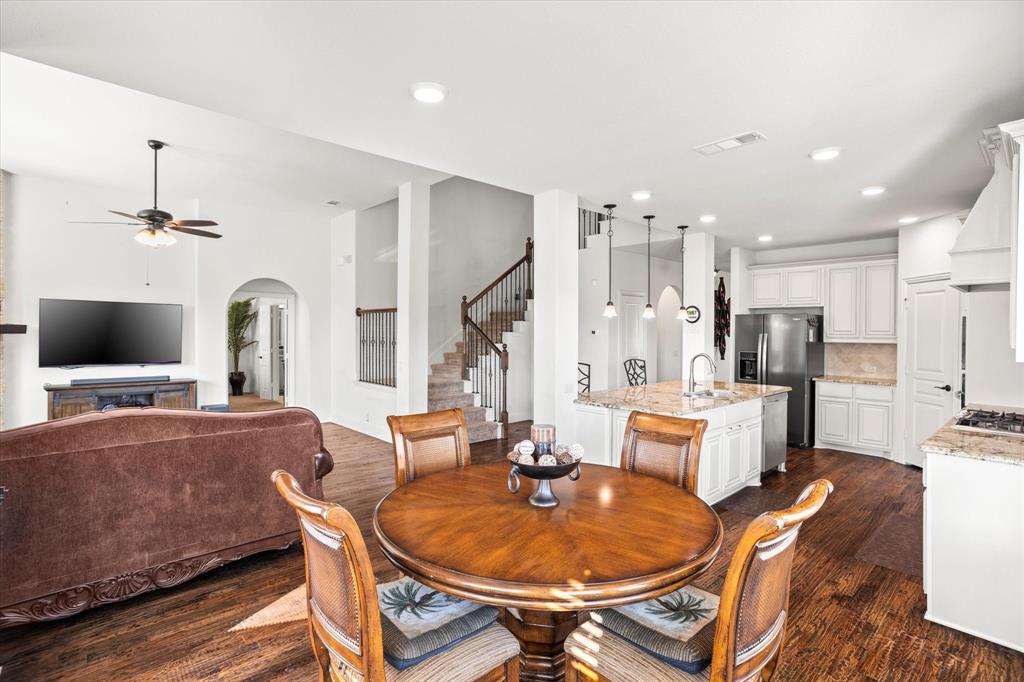 1814 Chadwick Lane Forney, TX 75126 - Photo 17 of 40 Dining area with arched walkways, dark wood-type flooring, stairs, recessed lighting, and a ceiling fan