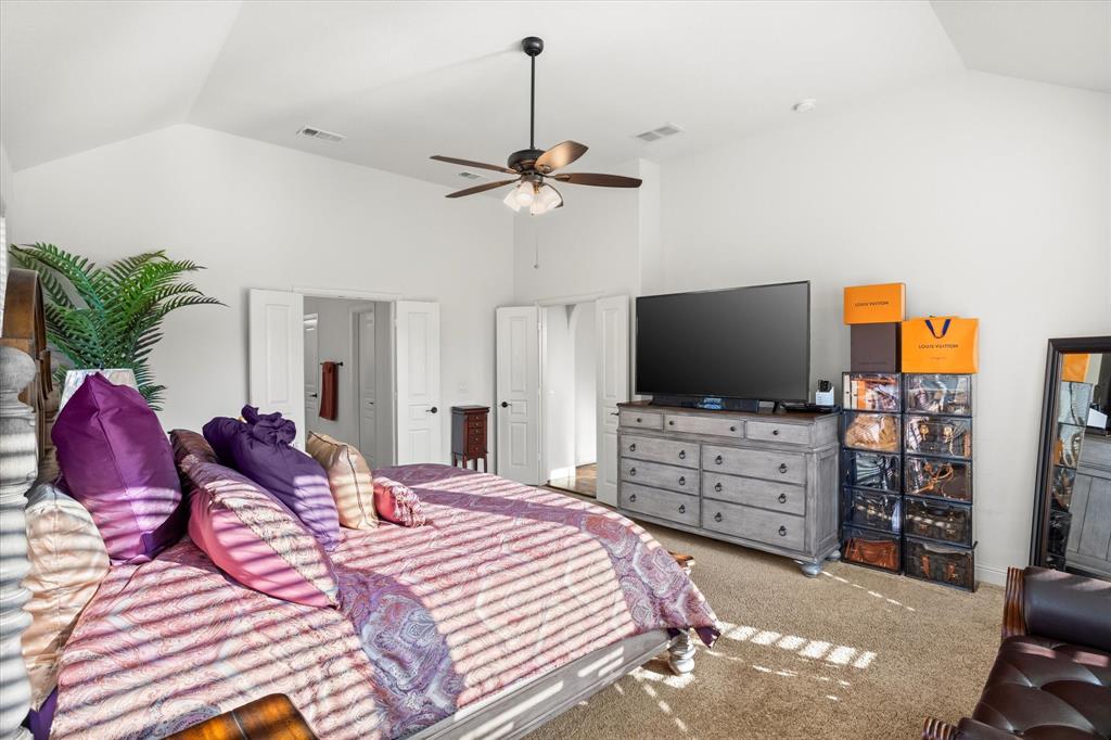 1814 Chadwick Lane Forney, TX 75126 - Photo 24 of 40 Bedroom featuring carpet floors, high vaulted ceiling, and a ceiling fan