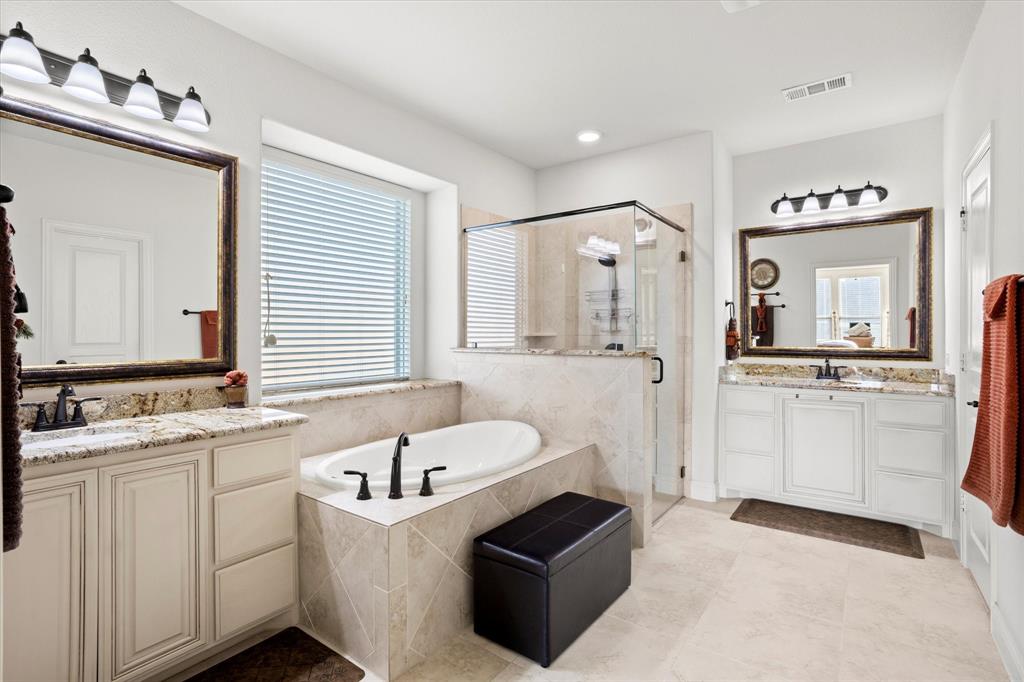 1814 Chadwick Lane Forney, TX 75126 - Photo 25 of 40 Full bathroom with a stall shower, plenty of natural light, a garden tub, and two vanities