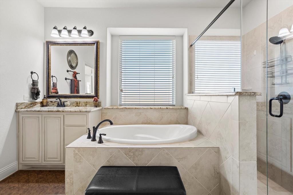 1814 Chadwick Lane Forney, TX 75126 - Photo 27 of 40 Bathroom featuring healthy amount of natural light, a bath, a stall shower, and vanity