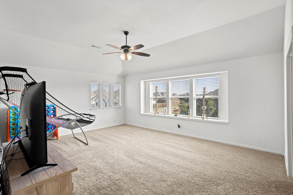 1814 Chadwick Lane Forney, TX 75126 - Photo 29 of 40 Game room featuring carpet flooring, lofted ceiling, and a ceiling fan