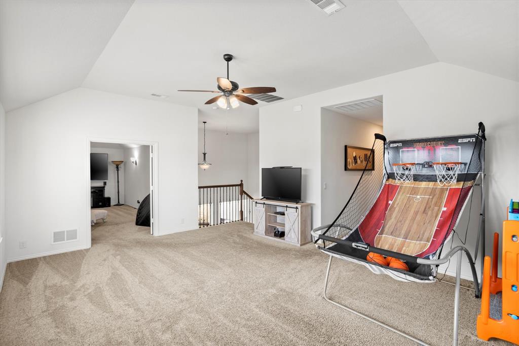 1814 Chadwick Lane Forney, TX 75126 - Photo 30 of 40 Recreation room featuring vaulted ceiling, carpet, and a ceiling fan