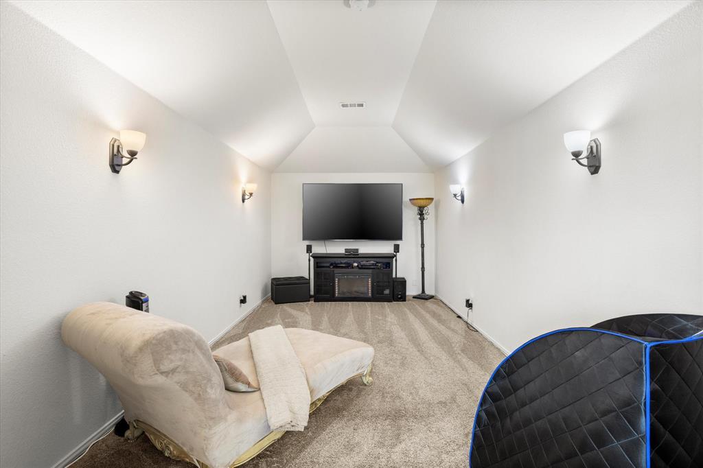 1814 Chadwick Lane Forney, TX 75126 - Photo 31 of 40 Cinema room featuring carpet and vaulted ceiling
