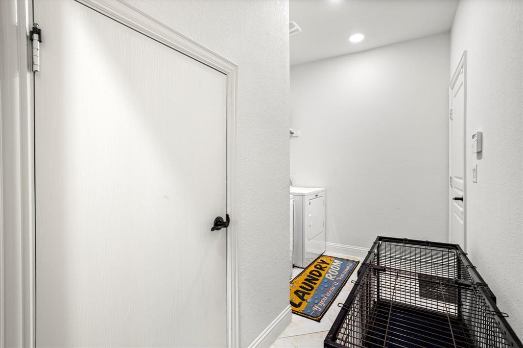 1814 Chadwick Lane Forney, TX 75126 - Photo 37 of 40 Hall with washer and clothes dryer, light tile patterned floors, a textured wall, and recessed lighting