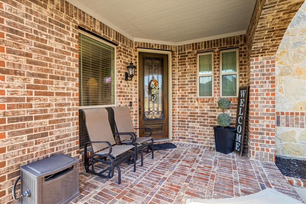 1814 Chadwick Lane Forney, TX 75126 - Photo 7 of 40 Entrance to property featuring brick siding and a porch