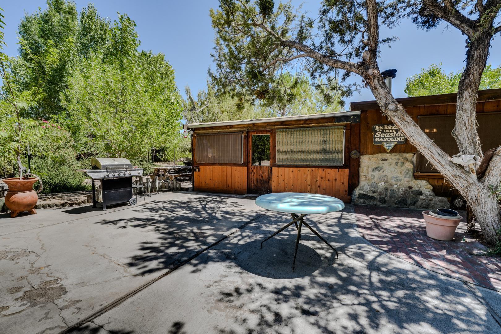 4160 Quatal Canyon Road Maricopa, CA 93252 - Photo 6 of 31 a backyard of a house with barbeque oven table and chairs
