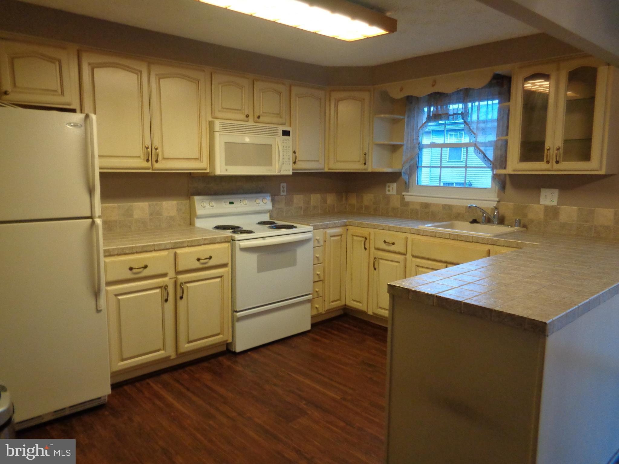 4020 Rustico Road Middle River, MD 21220 - Photo 15 of 59 a kitchen with a sink stove and cabinets