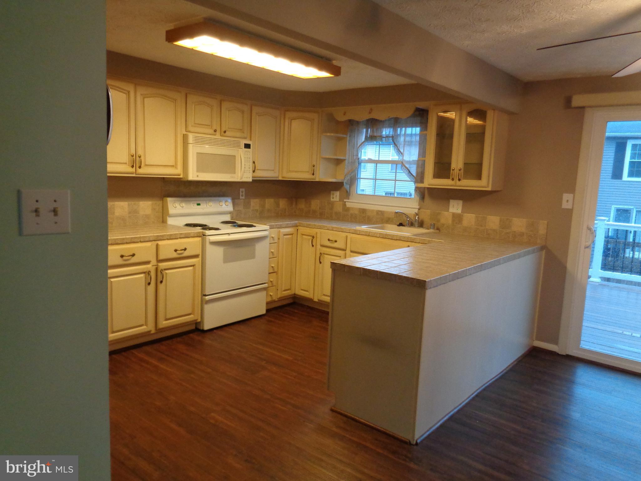 4020 Rustico Road Middle River, MD 21220 - Photo 20 of 59 a kitchen with a sink stove and cabinets