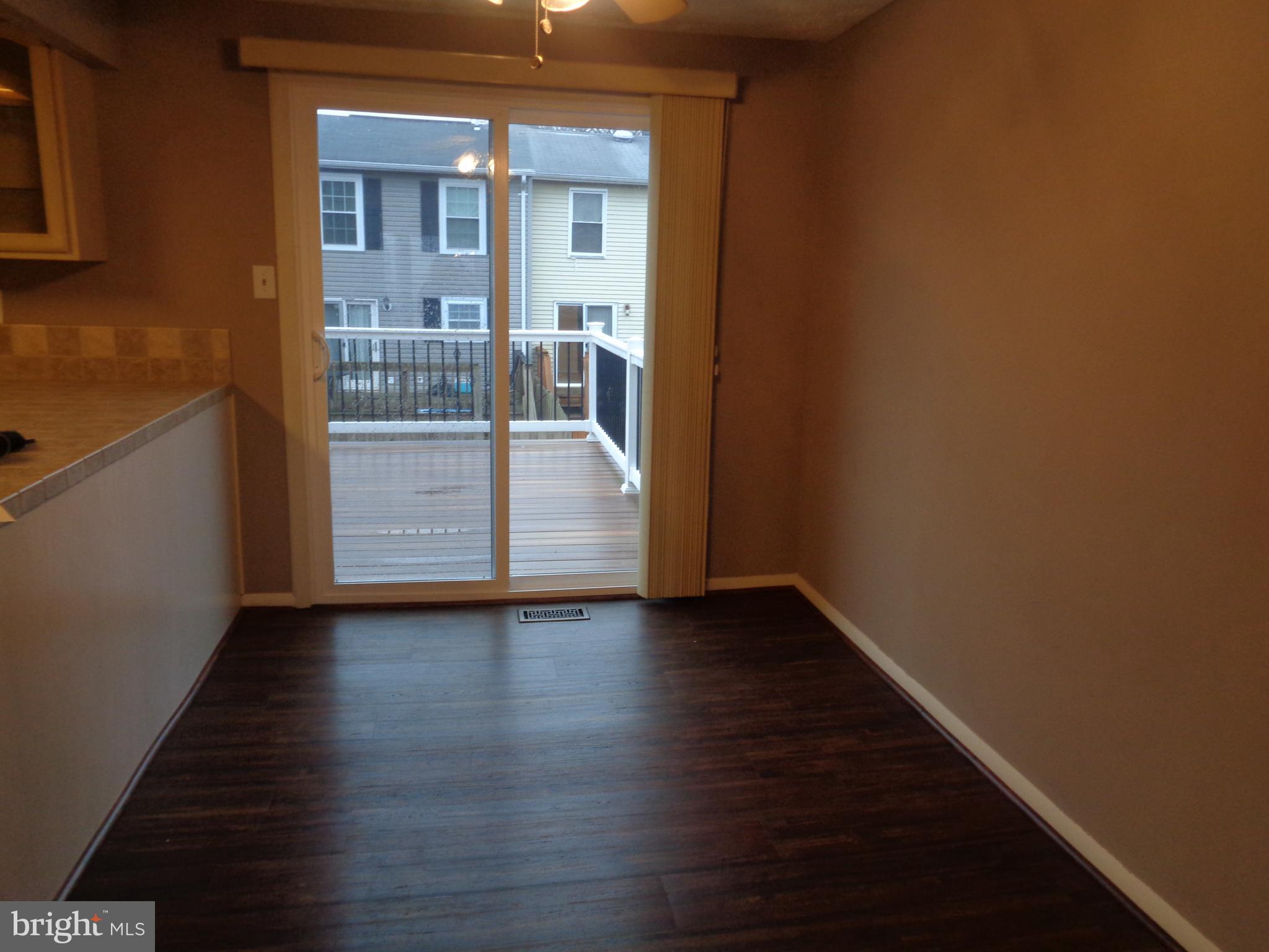 4020 Rustico Road Middle River, MD 21220 - Photo 25 of 59 a view of an empty room with wooden floor and a window