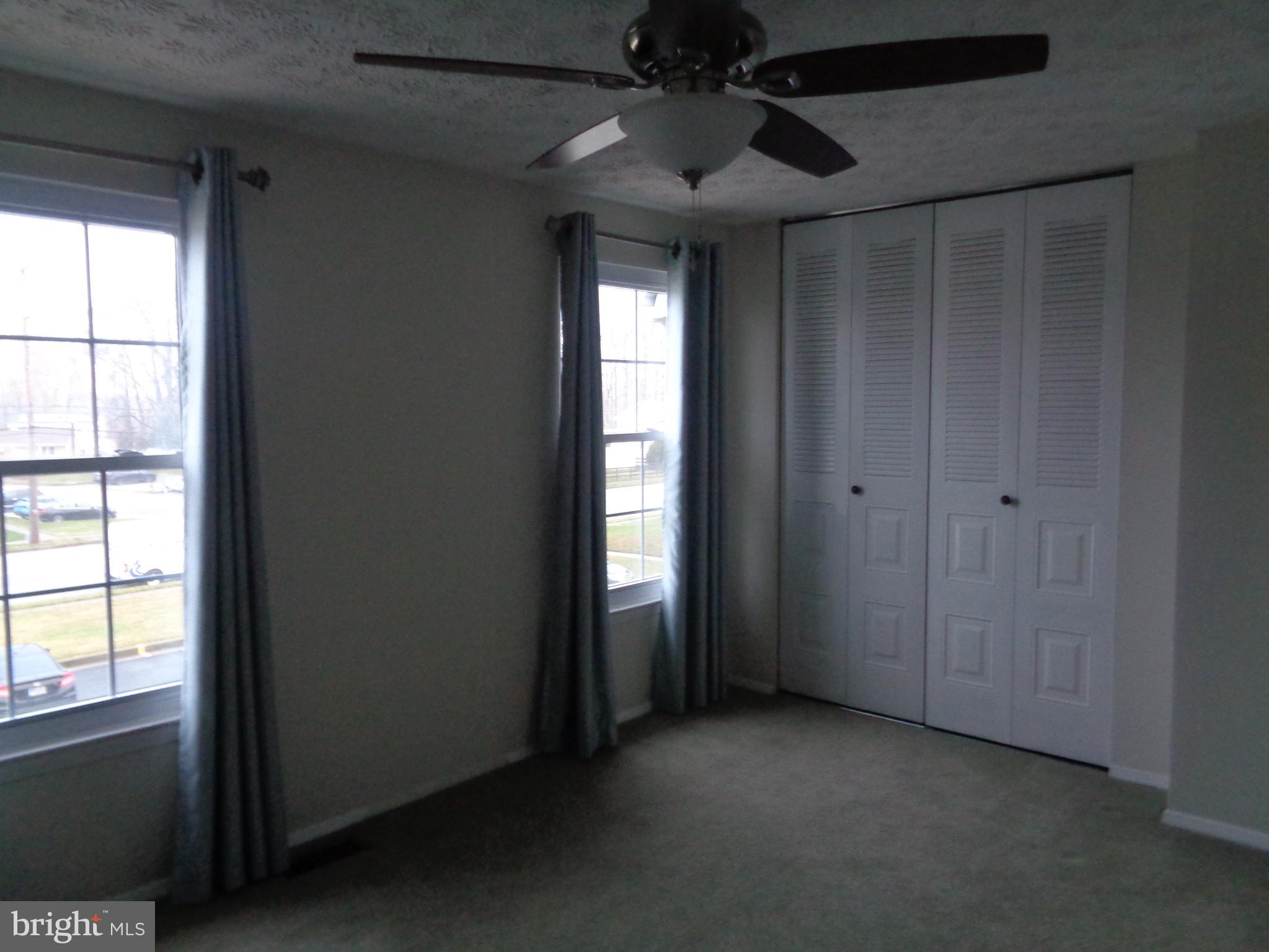 4020 Rustico Road Middle River, MD 21220 - Photo 34 of 59 an empty room with windows and chandelier fan