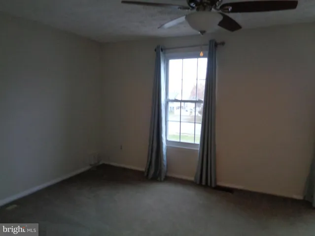 a view of an empty room and a window