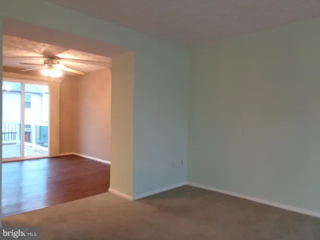 a kitchen with a white cabinets and wooden floor