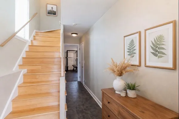 a view of entryway and hall with wooden floor