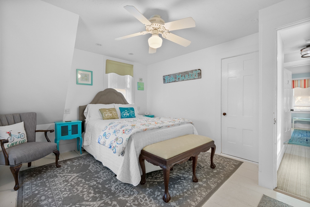 436 South Main Street Barnstable, MA 02632 - Photo 18 of 42 a bedroom with a bed and a chandelier