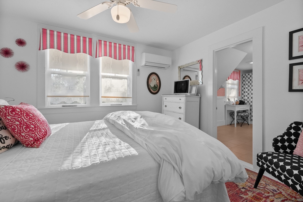 436 South Main Street Barnstable, MA 02632 - Photo 20 of 42 a bedroom with a bed and dresser with mirror