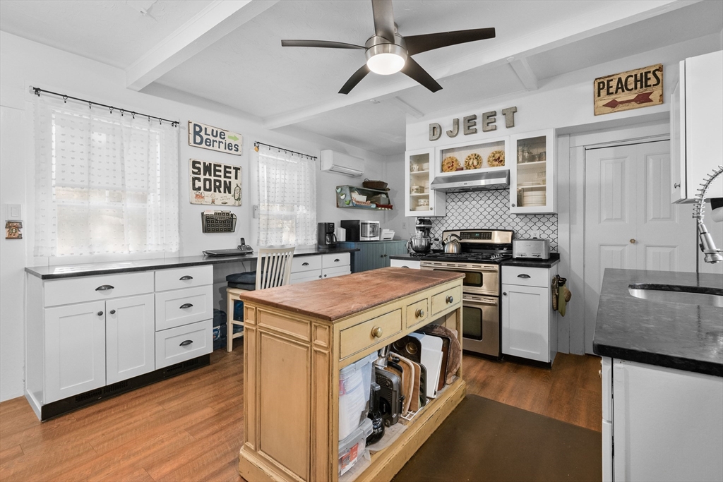 436 South Main Street Barnstable, MA 02632 - Photo 2 of 42 a kitchen with cabinets stainless steel appliances and wooden floor