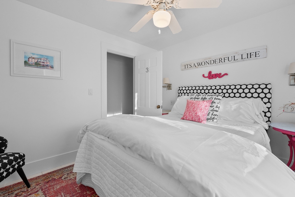 436 South Main Street Barnstable, MA 02632 - Photo 21 of 42 a bedroom with a bed and a chandelier