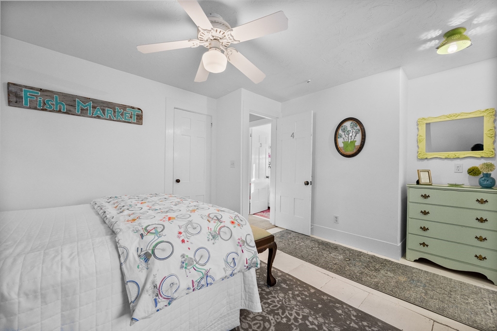 436 South Main Street Barnstable, MA 02632 - Photo 22 of 42 a bedroom with a bed and a chandelier