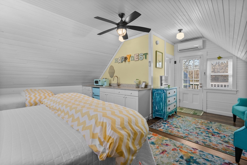 436 South Main Street Barnstable, MA 02632 - Photo 30 of 42 a bedroom with a bed and a chandelier