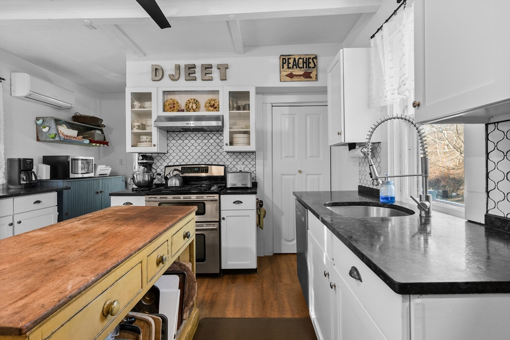 436 South Main Street Barnstable, MA 02632 - Photo 3 of 42 a kitchen with granite countertop a sink a stove and a wooden floor