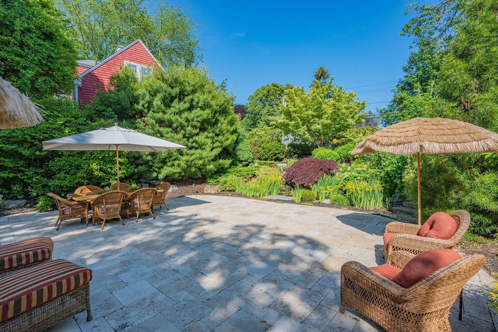 436 South Main Street Barnstable, MA 02632 - Photo 36 of 42 a backyard of a house with table and chairs under an umbrella