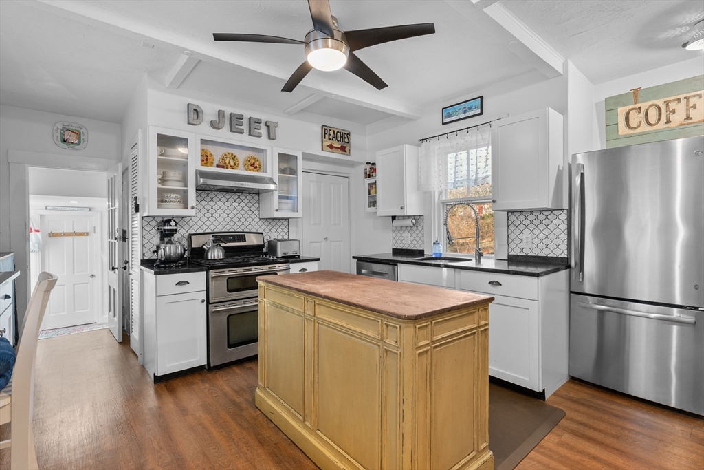 436 South Main Street Barnstable, MA 02632 - Photo 4 of 42 a kitchen with a refrigerator sink and cabinets