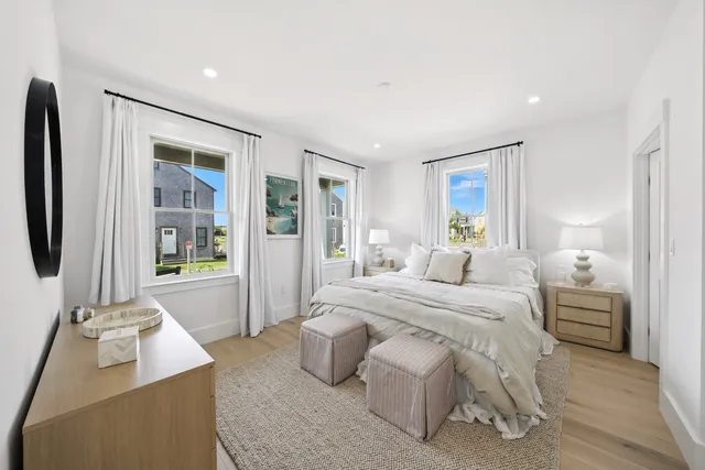 a spacious bedroom with a bed and glass door