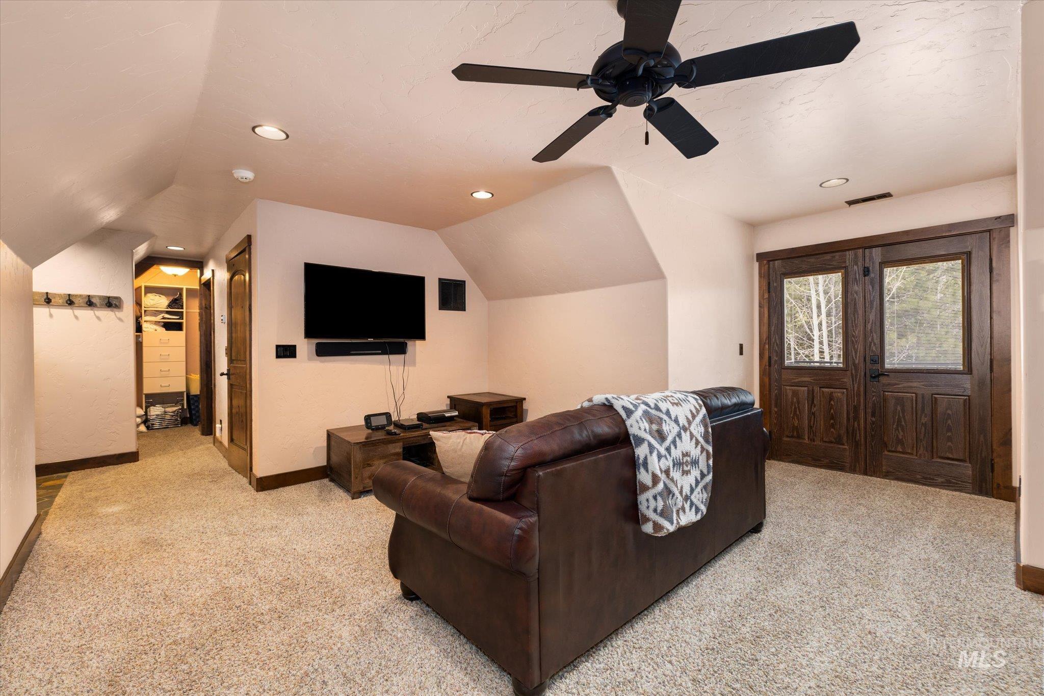 14 Pointe At Goldfork Court Donnelly, ID 83615 - Photo 27 of 49 Spacious carpeted room featuring vaulted ceilings, recessed lighting, a ceiling fan, and double wood-paneled doors with glass inserts