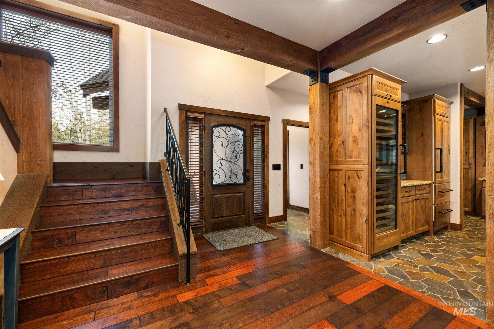 14 Pointe At Goldfork Court Donnelly, ID 83615 - Photo 3 of 49 Foyer featuring rich wood-finish flooring, a custom wood entry door with decorative glass, and a staircase with wrought iron railing